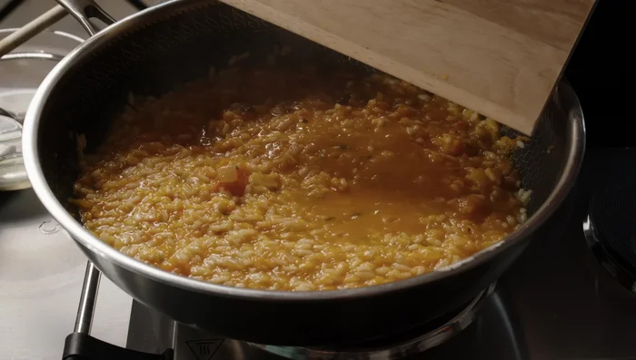 Add the smashed pumpkin to the rice.
