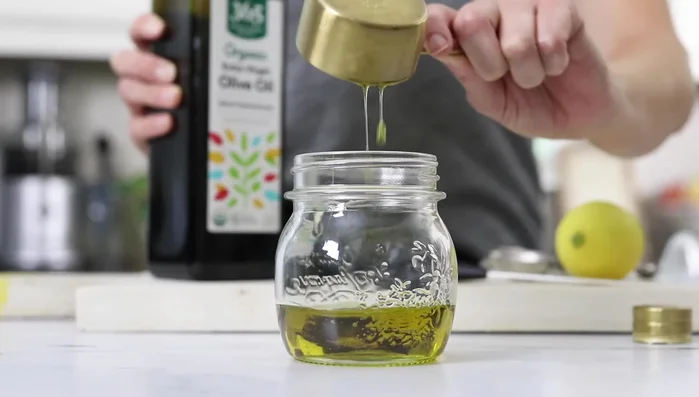 In a mason jar, combine olive oil, red wine vinegar, lemon juice, Dijon mustard, garlic powder, oregano, salt, and pepper. Shake well. (105.96)