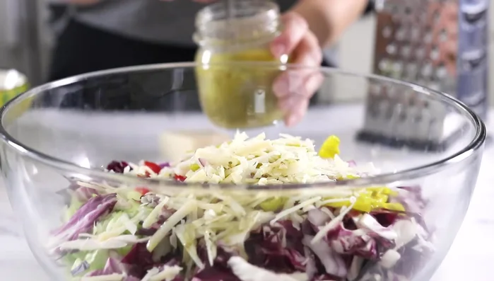 Add parmesan cheese (optional). Pour half the dressing over the salad and toss well. (183)