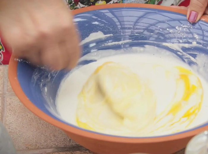Add the eggs and mix well. This helps prevent the fritters from soaking up too much oil.