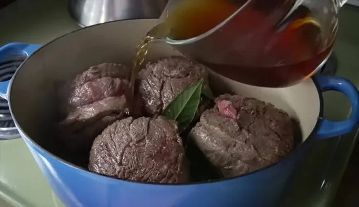 Add 3 bay leaves and 2 cups of beef stock. Bring to a boil, then reduce to a simmer. Cover and slow-cook for 3-3.5 hours until tender.