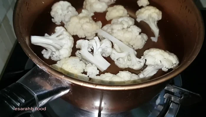 Cut cauliflower into chunks, soak in salt water, and blanch for 2 minutes max. Rinse in cold water.