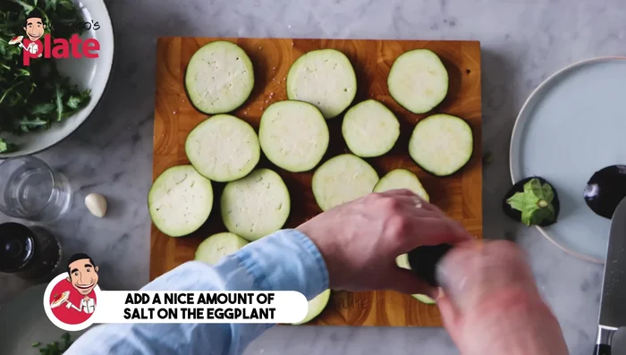 Generously salt the eggplant slices and let them rest for 5 minutes.
