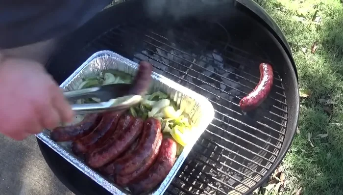 Assemble the sandwiches: Place the cooked sausages on buns. Top with sauteed peppers and onions, and add spicy brown mustard.