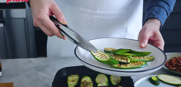 Once grilled, place the zucchini on a serving plate.