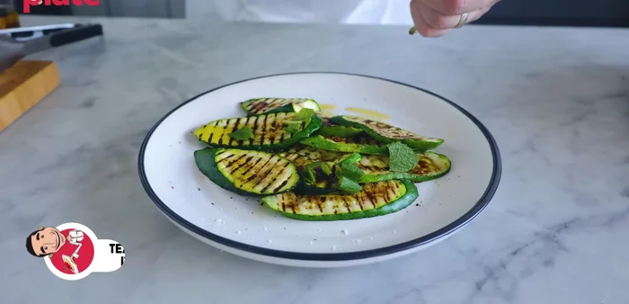 Roughly chop the fresh mint and scatter it over the zucchini.