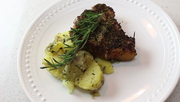 Serve the veal chops with the grilled potatoes and garnish with extra rosemary.