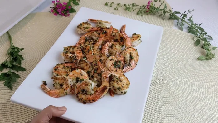 Transfer the cooked shrimp to a serving plate.