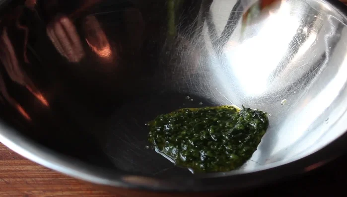 In a bowl, combine the remaining herb mixture with red pepper flakes, cayenne pepper, lemon juice, and a drizzle of olive oil. Whisk to make a sauce.
