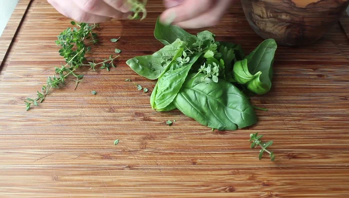 Prepare the herbs by removing leaves from stems. This is easiest for most herbs except thyme, which takes a bit longer.