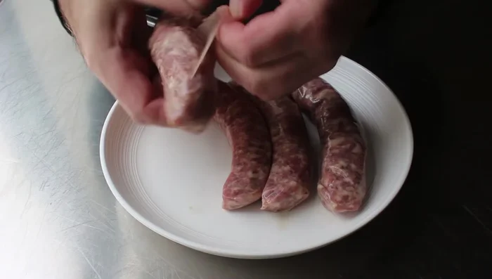 Remove sausage casings and brown the sausage in a dry pot over medium-high heat, breaking it up into small pieces.