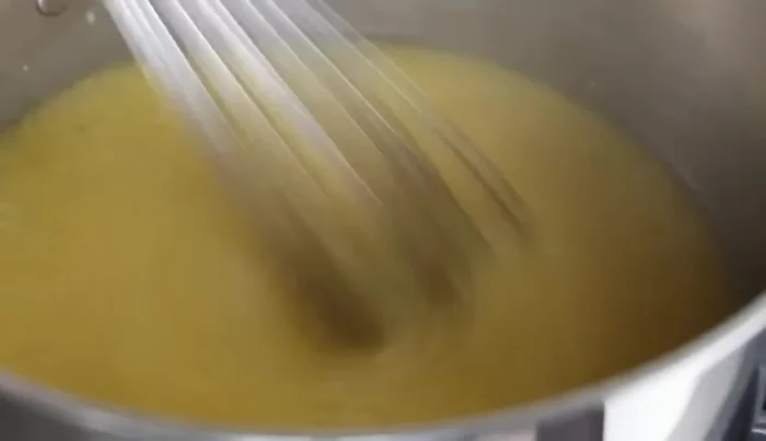 Reduce heat to low, continue stirring with a whisk until it starts to thicken.