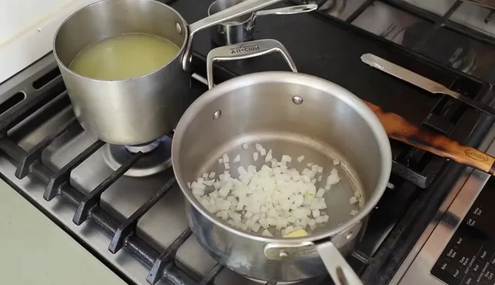 Start by cooking the onion in a pot until translucent.