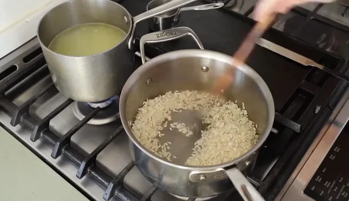 Add the risotto rice and toast it slightly.