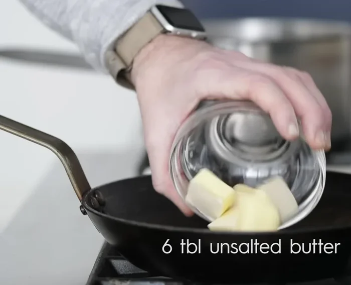 Make béchamel sauce: Heat milk in a pot. In a saucepan, melt butter, whisk in flour to create a roux (226.209). Gradually whisk in warm milk until thickened (239.2). Season with salt, pepper, and nutmeg (265.65).