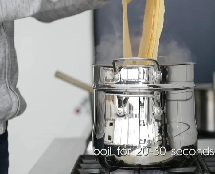 Parboil pasta: Cook lasagna noodles in batches for 20-30 seconds in boiling salted water (400.439). Drain and lay flat on a kitchen towel to prevent sticking (409.65).