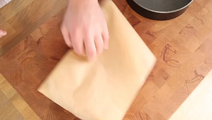 Butter a cake tin and create a cartouche (circle of baking parchment) to fit the base. This ensures easy cake removal.