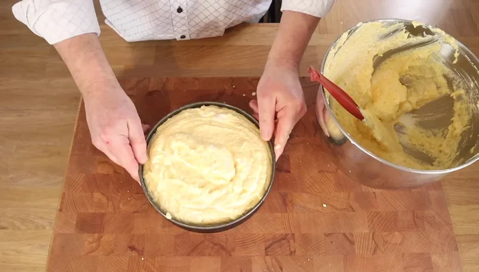 Pour the batter into the prepared cake tin, smoothing the top. You can use any leftover batter for a smaller loaf cake.