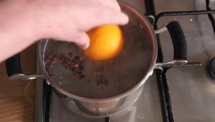 Boil water with cloves, juniper berries, and star anise. Gently poach whole oranges for one hour. Let them cool completely and refrigerate for about 30 minutes.