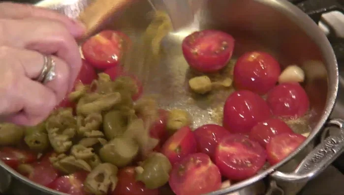 Add green olives and capers to the sauce.