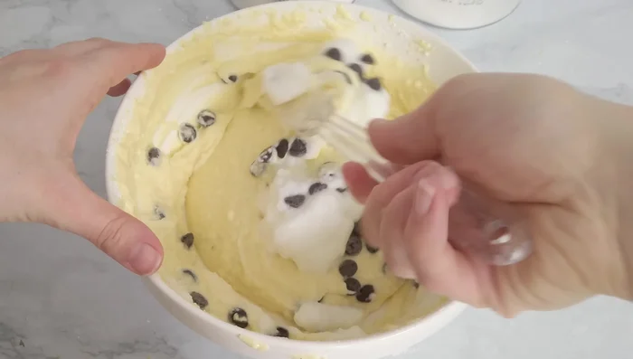 Gently fold egg whites and chocolate chips into the ricotta mixture. [114.88]