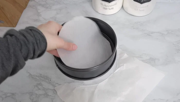 Prepare a 7-inch pan with parchment paper, lightly buttering it for better adhesion. [40.92]