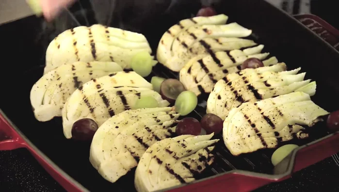 Place the fennel (along with some whole and halved grapes) in the oven and roast for 8-10 minutes.