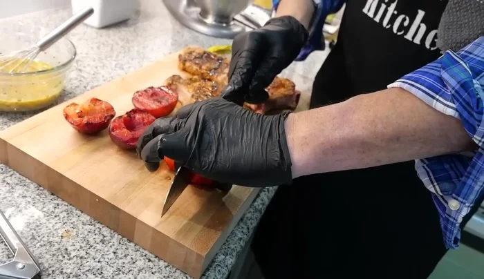 Cut the rested pork chops into pieces and add them to the plum mostarda vinaigrette.