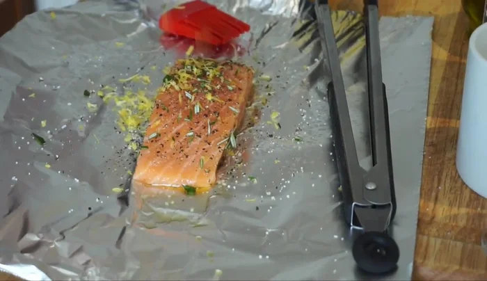 Add lemon zest, 3 lemon slices, and 1 tablespoon of lemon juice to the salmon.