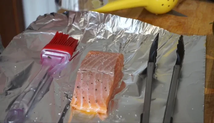 Drizzle olive oil on salmon fillets. Sprinkle with salt, pepper, and rosemary. Flip and repeat on the other side.