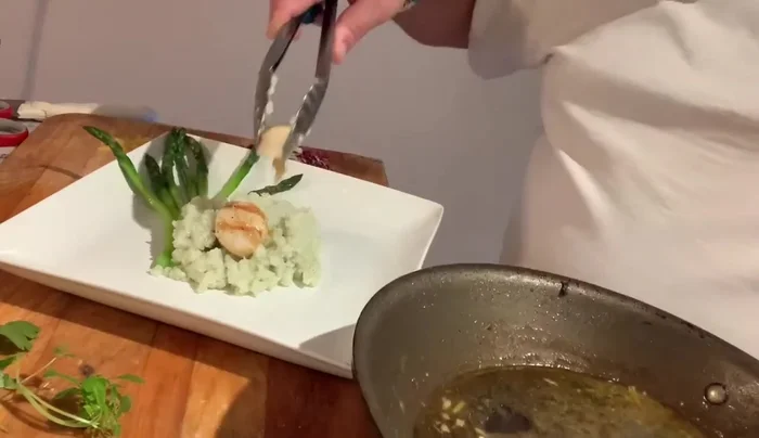 Gently place the seared scallops on top of the risotto.