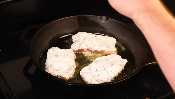 Sear the veal in a hot cast iron pan for 4 minutes per side, until golden brown and crispy. (212.28)