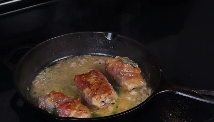 Simmer the veal in the sauce for a few minutes, ensuring it's coated evenly. (260.919)
