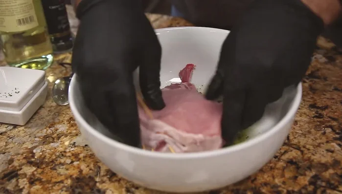 Marinate the pork chop, pressing firmly to incorporate the ingredients.