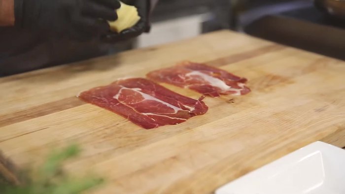Prepare the stuffing: Layer thinly sliced prosciutto with cheese. Roll tightly, pressing firmly.