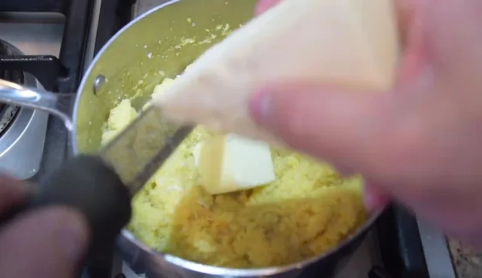 Finish polenta: Once the polenta is cooked, stir in the remaining 2 tablespoons of butter and 1/2 cup of grated parmesan cheese.