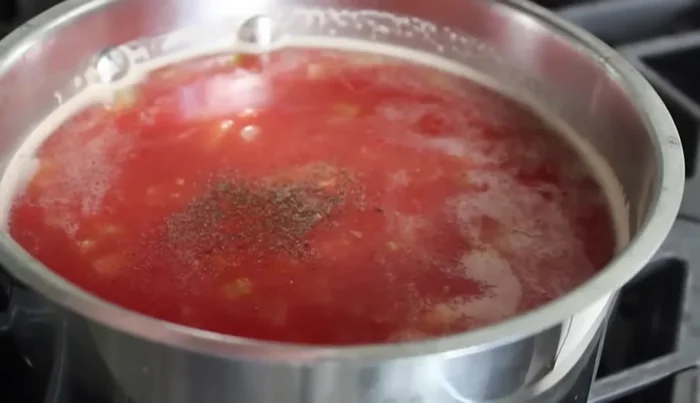 Season with black pepper, cayenne, and paprika. Add more salt if needed. Add sugar (amount depends on tomato sweetness).