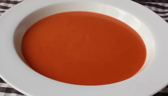 Ladle into warm bowls and garnish with fresh cream and basil.