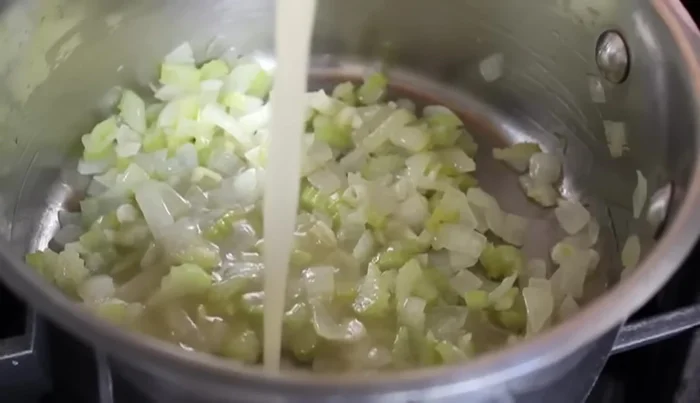 Pour in chicken broth (or vegetable stock/water), stir, and add the crushed San Marzano tomatoes.