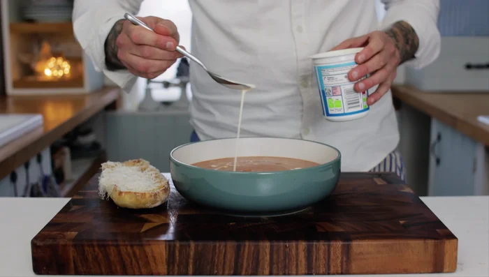 Serve soup drizzled with cream and extra virgin olive oil (1:84.56).
