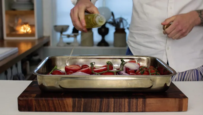 Drizzle with olive oil, season with salt and pepper (0:58.039). Add extra olive oil to the top of the garlic (0:67.28).