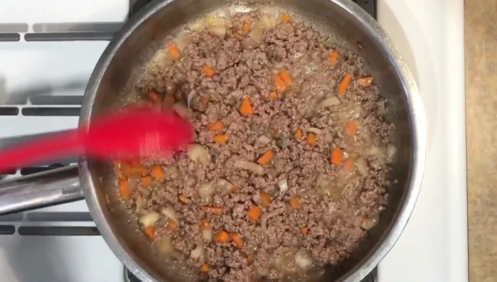 Let the meat mixture cool and then break it into smaller pieces for stuffing.