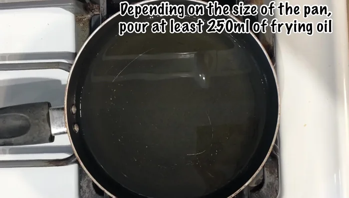 Heat frying oil in a large or medium pan. Once hot, fry the stuffed olives, turning frequently to ensure even cooking and prevent burning. Lower heat if necessary.