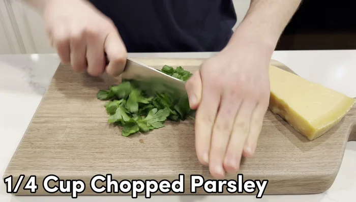 While potatoes cool, prepare the other ingredients: finely chop ¾ cup parsley, grate ½ cup Parmesan cheese.