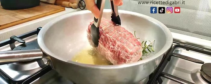 Add rosemary, chili pepper, and a halved garlic clove to the pan.