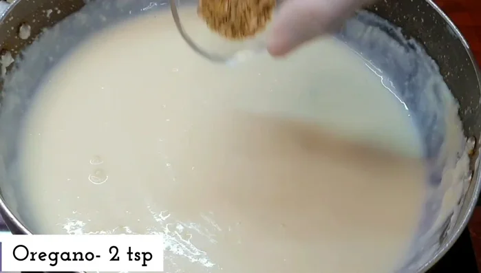 Add 2 teaspoons of oregano, 2 teaspoons of chili flakes, 2 teaspoons of black pepper powder, and 1 teaspoon of salt to the sauce. Cook on low heat for 6-7 minutes until creamy and smooth.