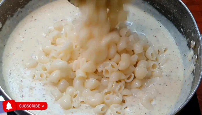 Add the boiled pasta to the white sauce and mix well. Cook on low heat for 5-7 minutes to allow flavors to blend.