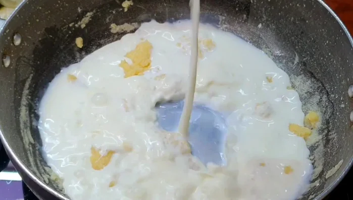Slowly add 1 cup of milk, whisking constantly until smooth.