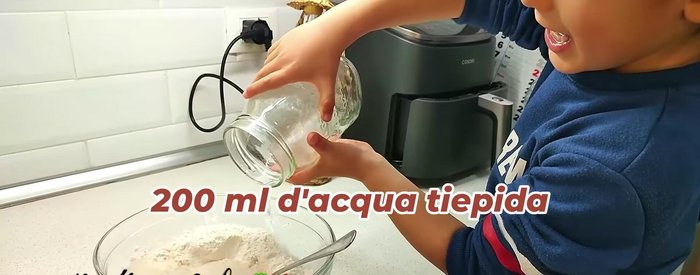 Gradually add warm water, mixing and kneading the dough until smooth and elastic.