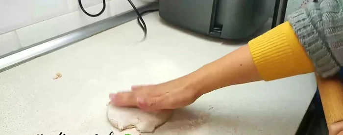 Roll out the dough very thinly using a rolling pin.
